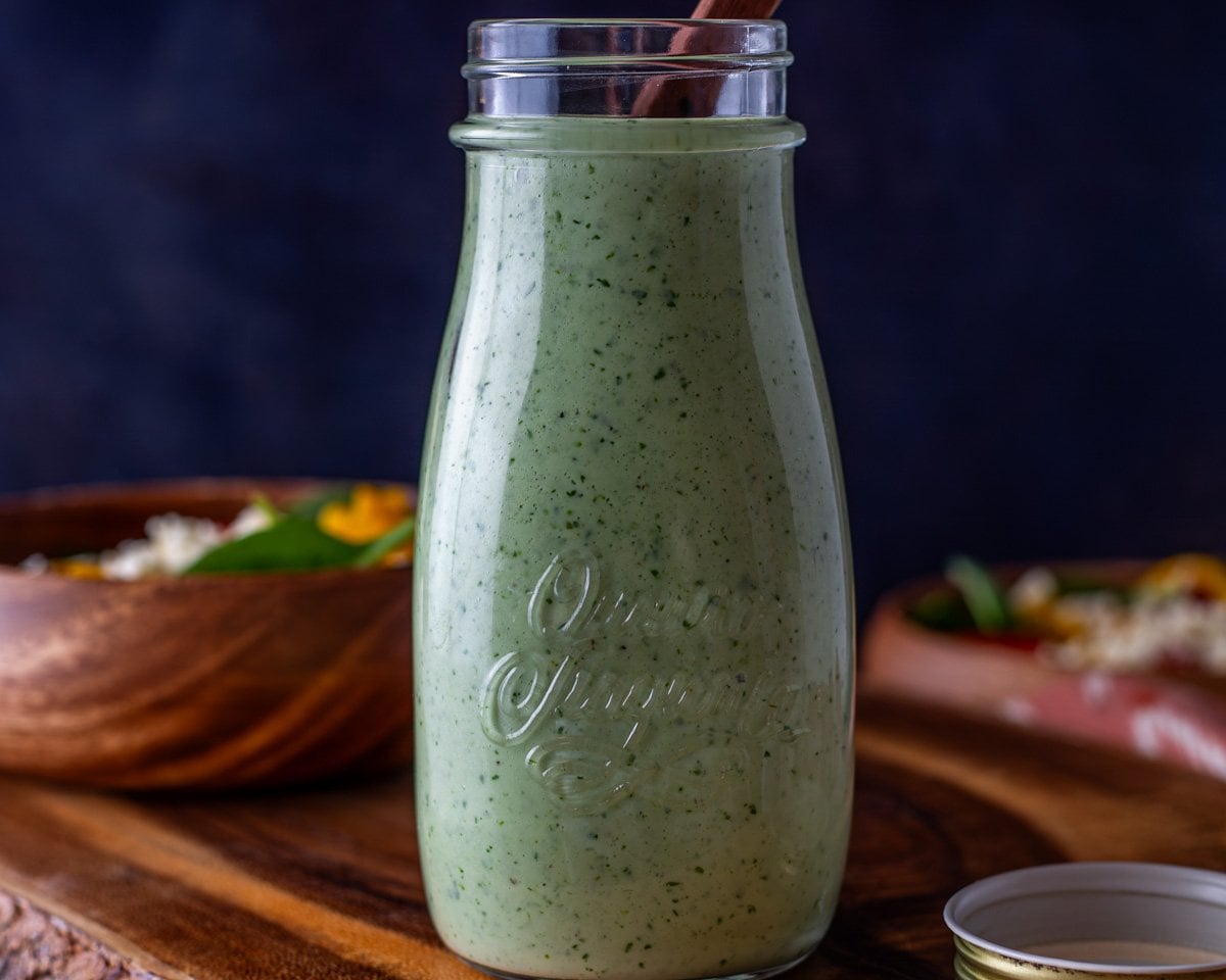 Cilantro Lime Ranch Dressing close up on a wood cutting board.