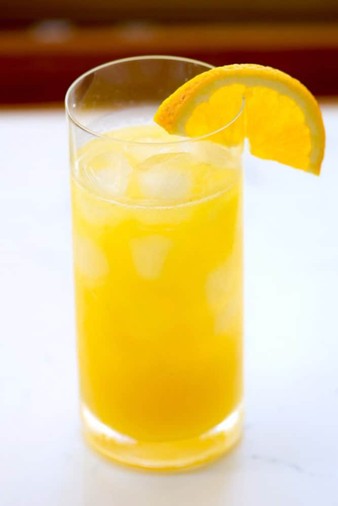 A fresh mango cocktail in a highball glass.
