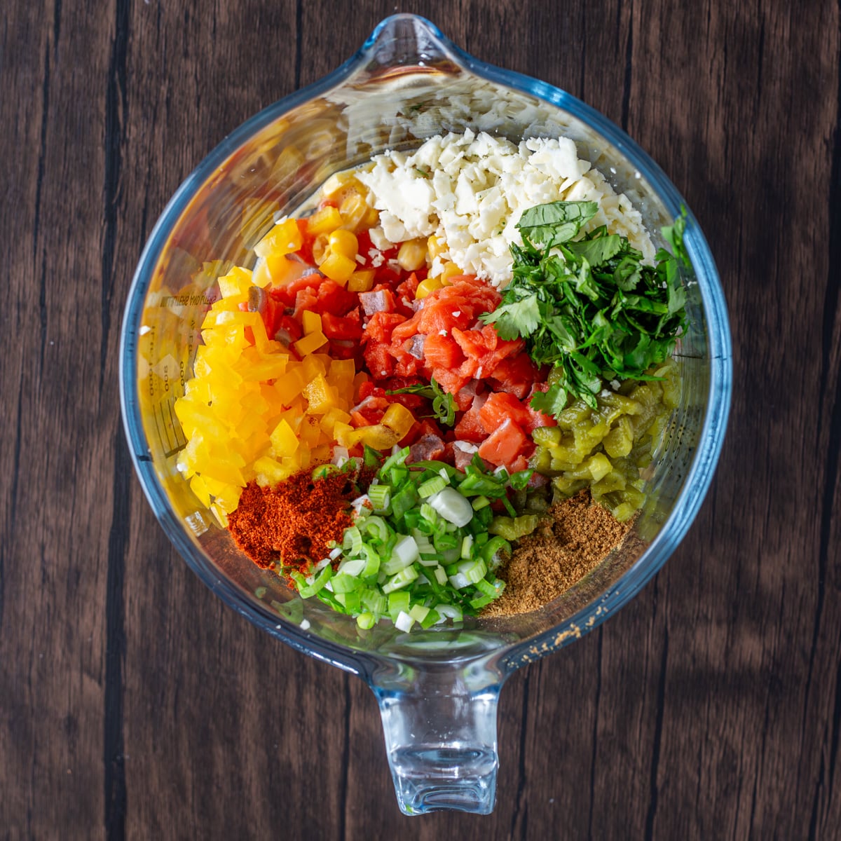 Spicy Mexican Salmon Patties with Creamy Cilantro Ranch and Spinach Salad - A green prep bowl with Mexican Salmon Patties mixture ready to go!