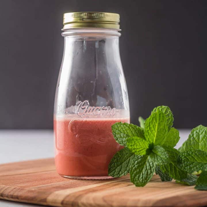 A glass bottle of pomegranate and blood orange vinaigrette.