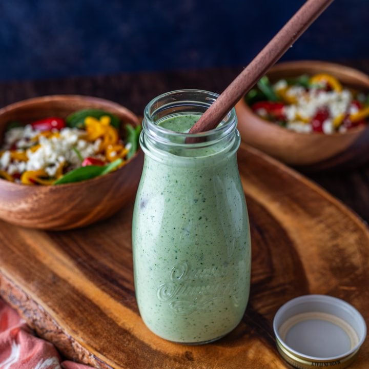 Cilantro Jalapeno Ranch Dressing - dressing being poured on to a plate of salad.