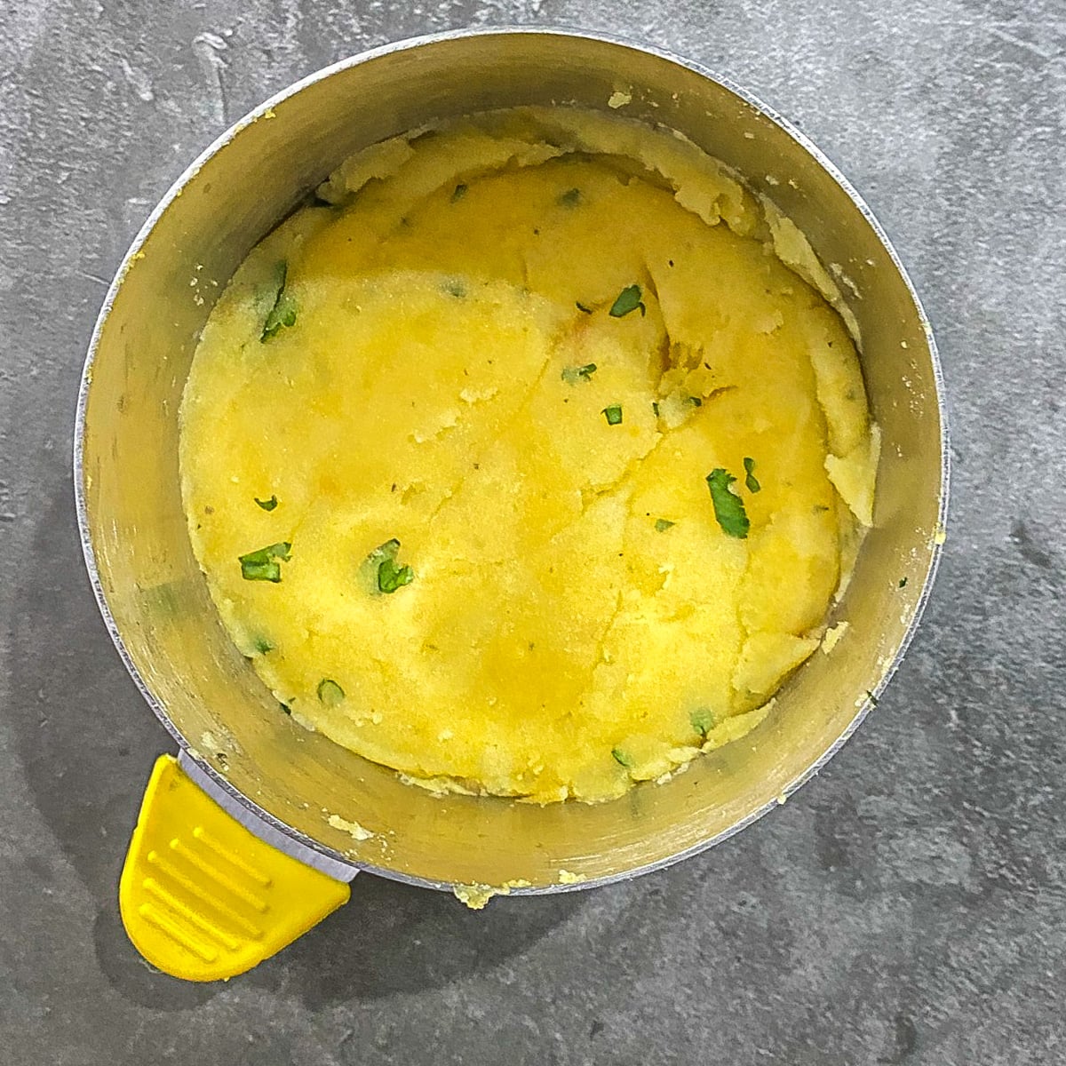 Step 2 - The yellow potato mixture is pressed in the ring mold.