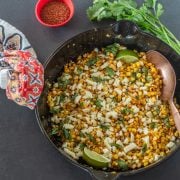 Cast iron skillet with charred sweet corn and homemade taj&iacute;n.