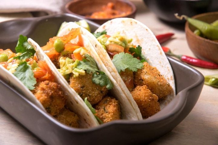 Fusion kimchi tacos with cod in a baking pan.