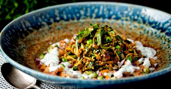 Keema rice with ground lamb in a brilliant blue and brown stoneware bowl.