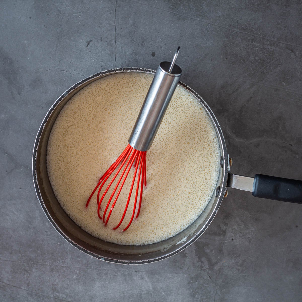 Step 3 - Add the tempered egg yolk mixture back into the saucepan, and gently bring to a simmer. DO NOT BOIL.