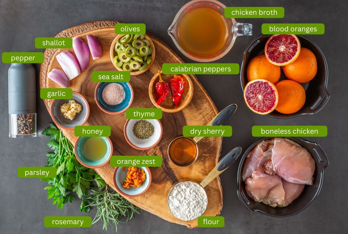 Ingredients for Mediterranean blood orange chicken including chicken thighs, blood oranges, peppers, and shallots.