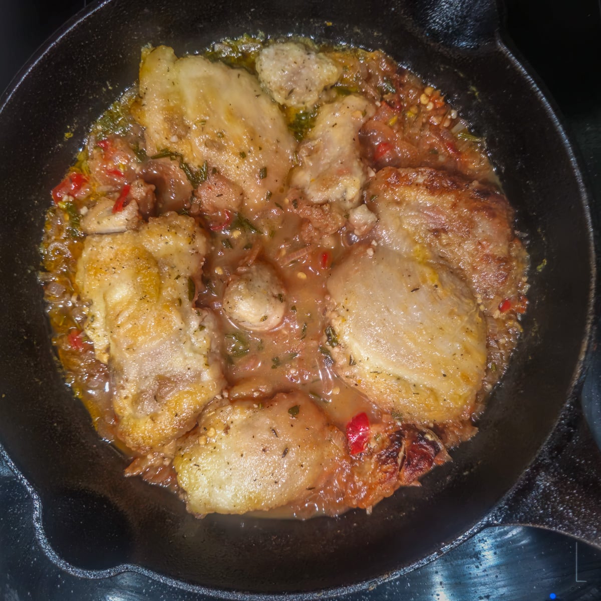 Step 6 - The chicken is simmered until tender in a cast iron skillet.