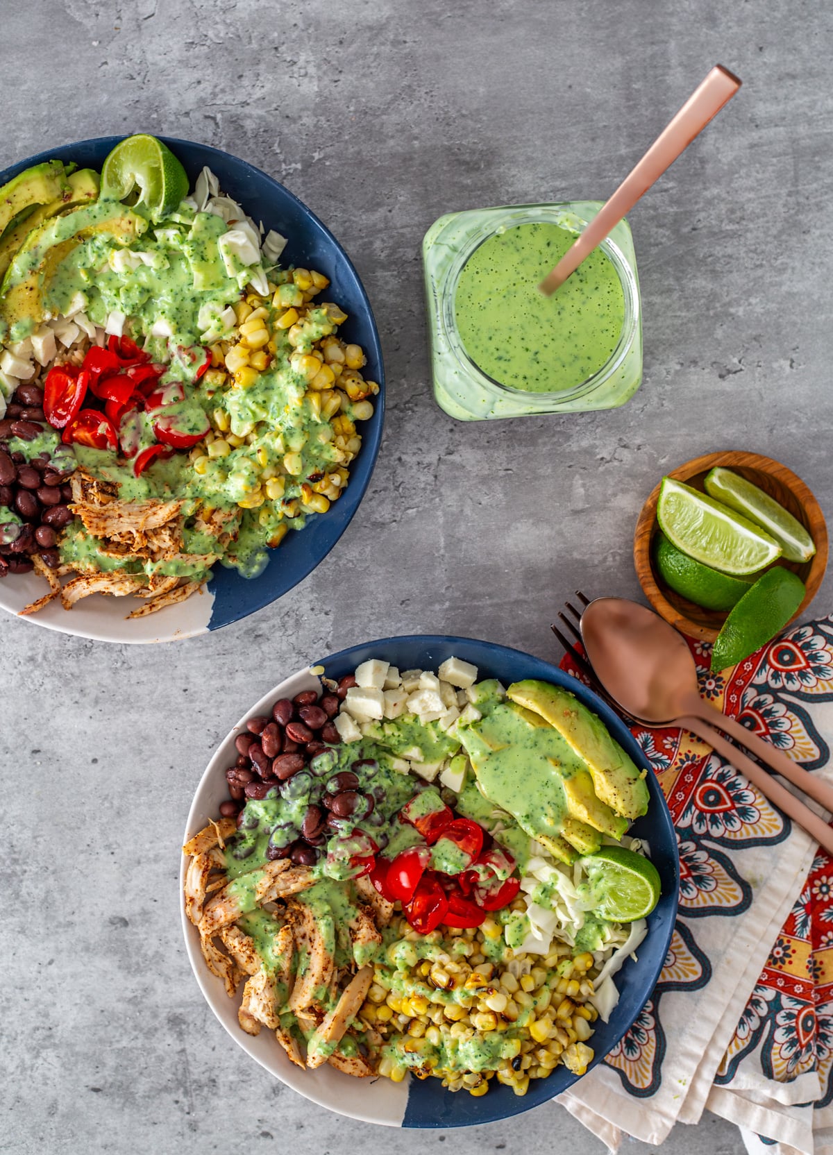 Blue and white bowls with rotisserie chicken taco bowls, and creamy cilantro ranch dressing.