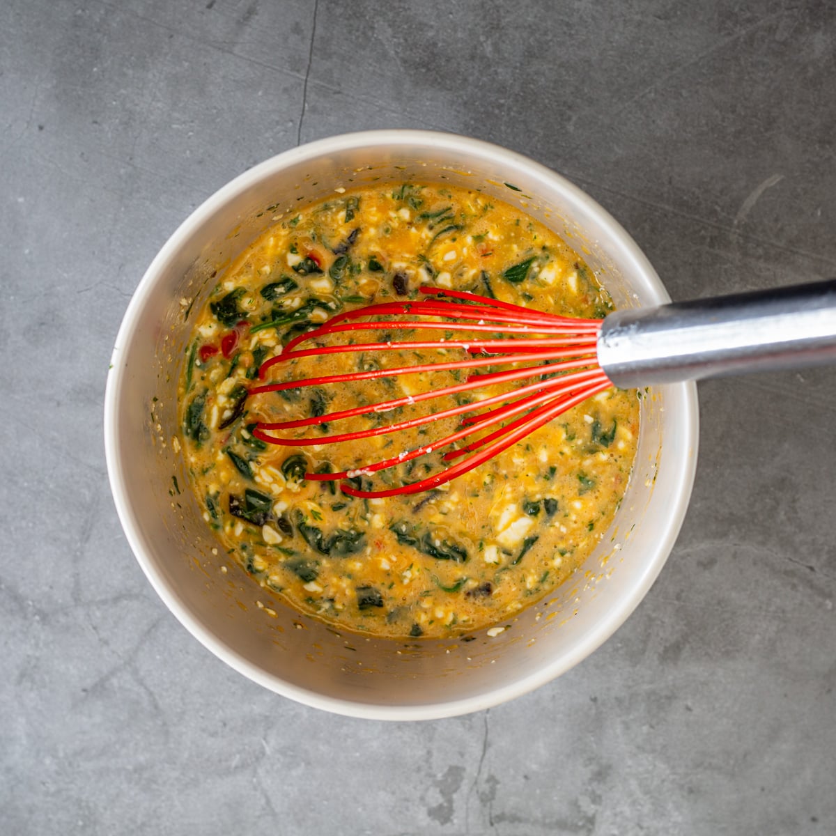 Step 1 - All ingredients are whisked together in a grey mixing bowl.
