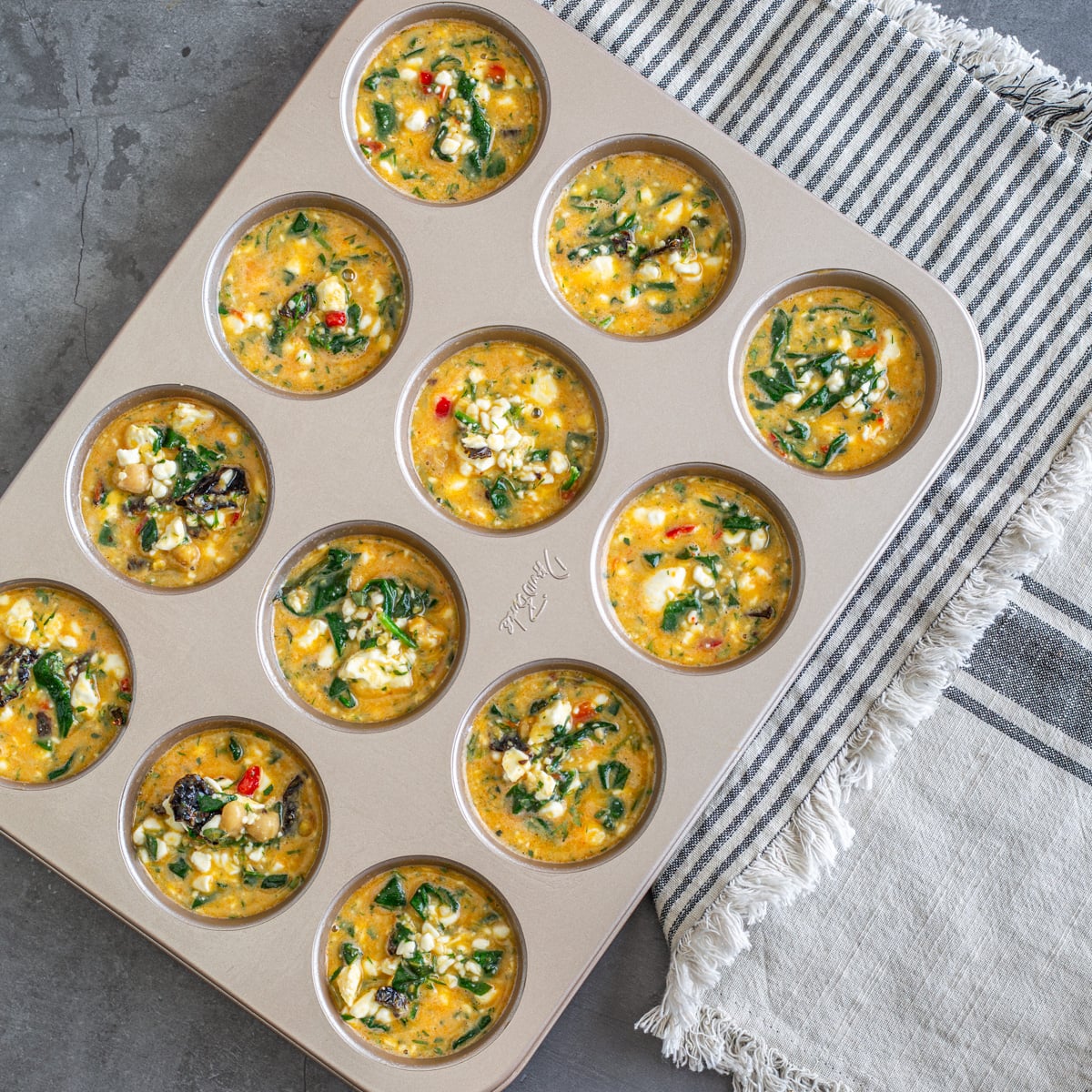 Step 2 - The egg and cottage cheese mixture is ladled into a beige muffin pan.