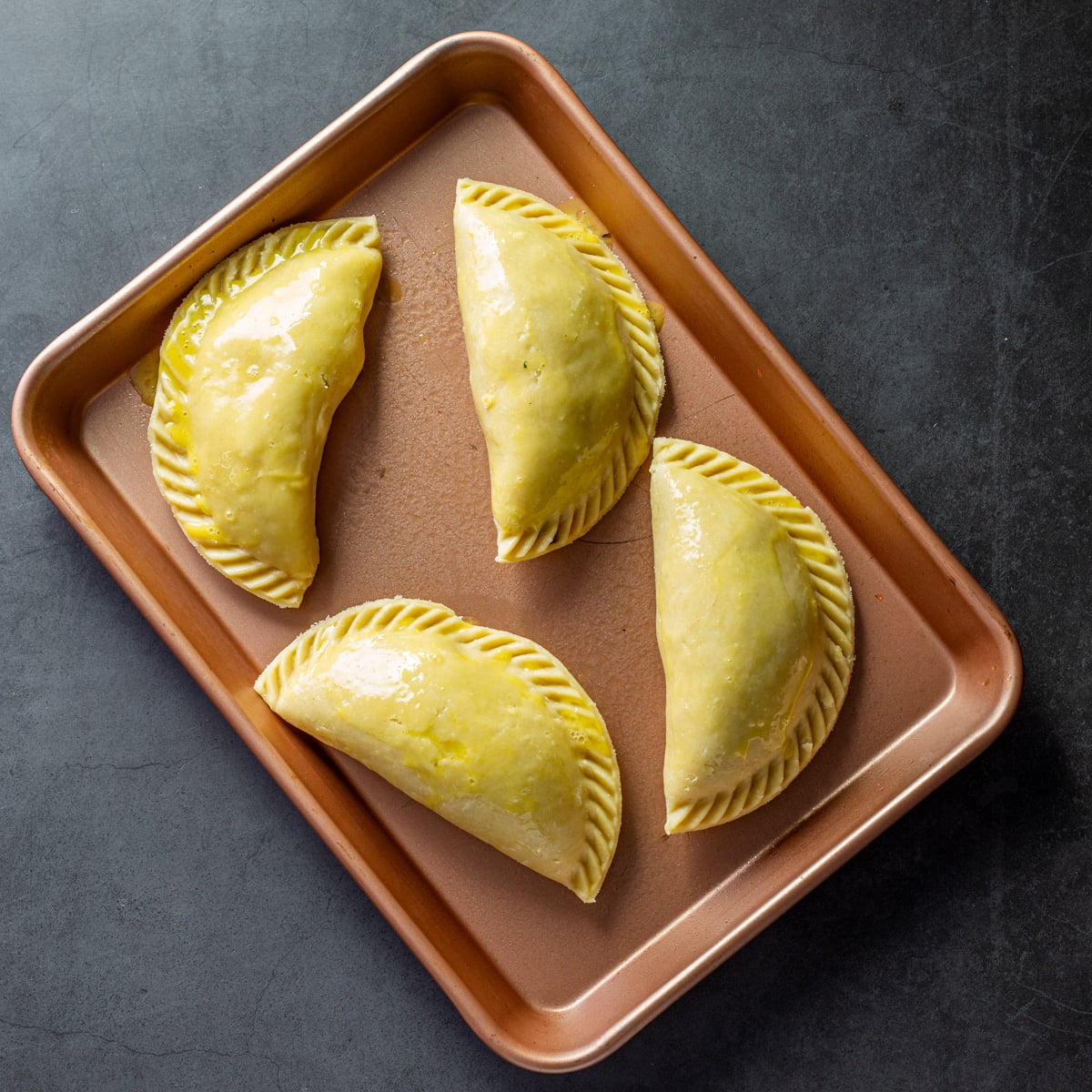 Step 6 - Place the Peruvian empanadas on a baking sheet after lightly spraying with cooking spray.