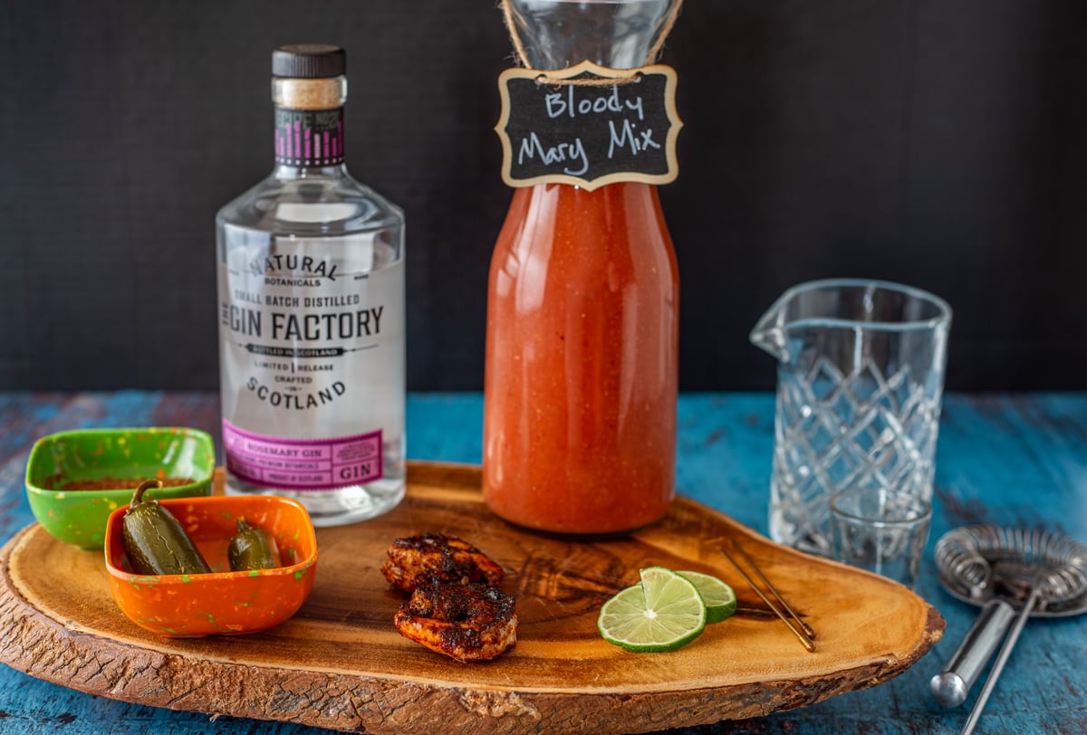 Ingredients for Bloody Mary with Gin including Bloody Mary mix, gin, and garnishes.