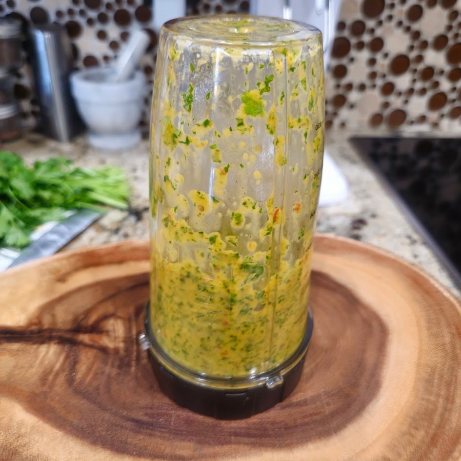 All chimichurri ingredients are added to the blender.