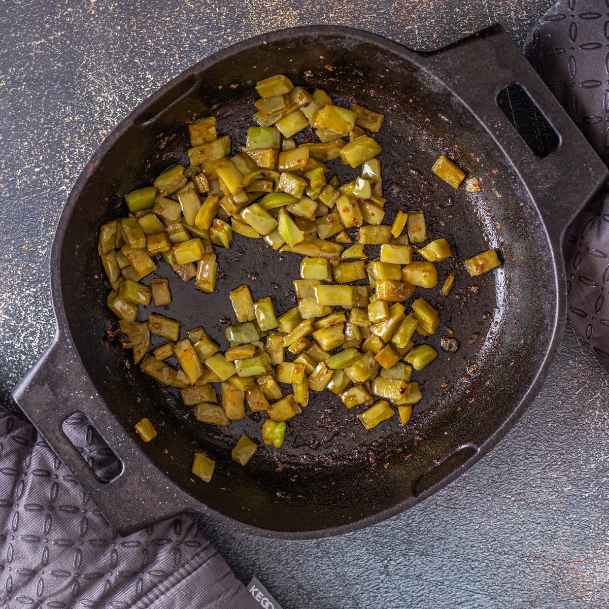 Step 3 - The nopales are cooked in the cast iron skillet until the mucilage is dry.