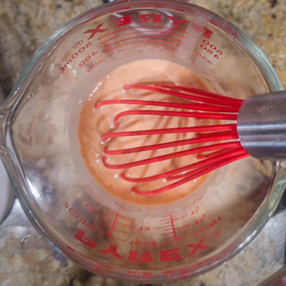 Step 4 - The Thai red curry paste is whisked with coconut milk and fish sauce in a glass bowl.