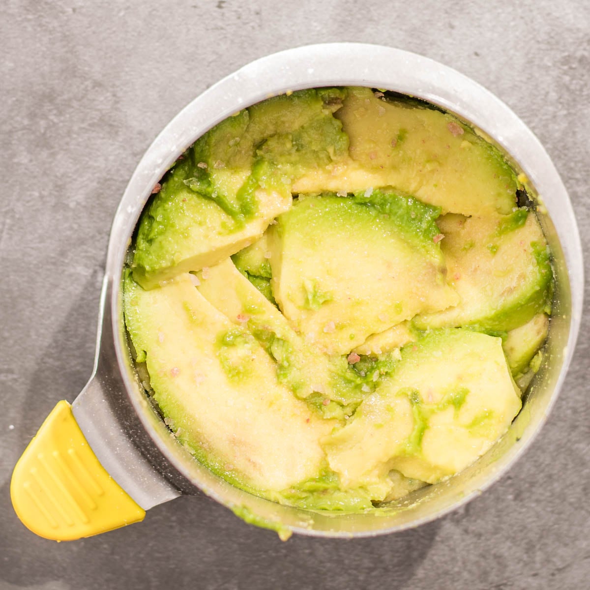 Avocado slices in the ring mold for the causa rellena.