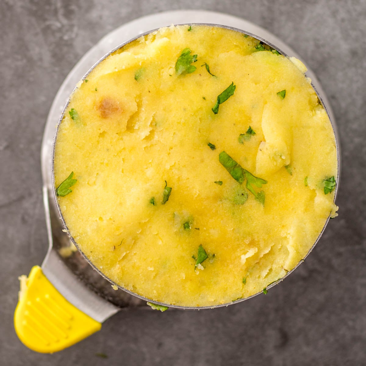 A second layer of mashed potatoes fills the ring mold for the tuna causa.