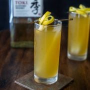 2 whisky and green tea cocktails with a bottle of Japanese whisky in the background.