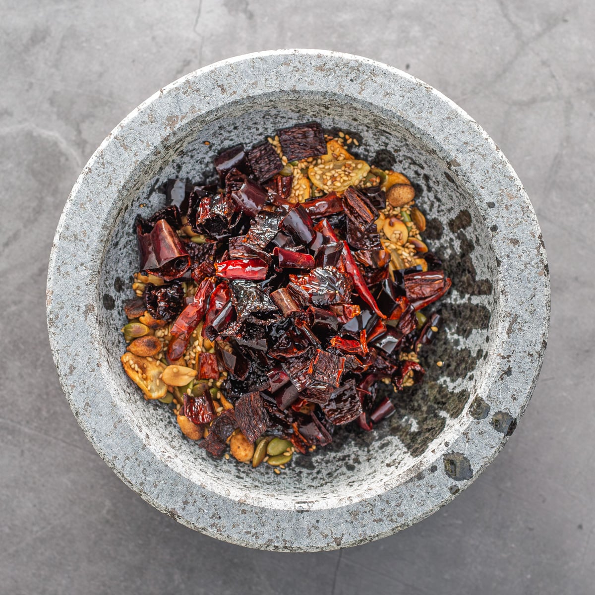 The molcajete with the fried red chiles added to nuts and seeds.