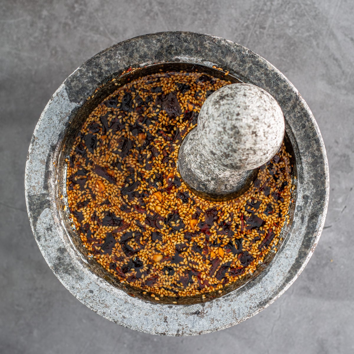 A molcajete with freshly ground salsa macha.
