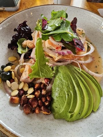 Avocado and ceviche on a white plate.