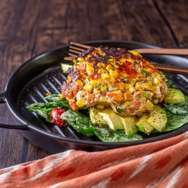 Spicy Mexican Salmon Patties with Creamy Cilantro Ranch and Spinach Salad - a square white plate with completed Mexican Salmon Patty.