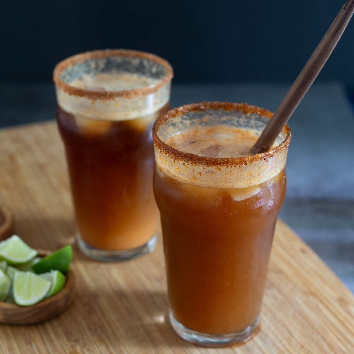 The Mexican beer is added to the glasses with the michelada mix, and stirred.