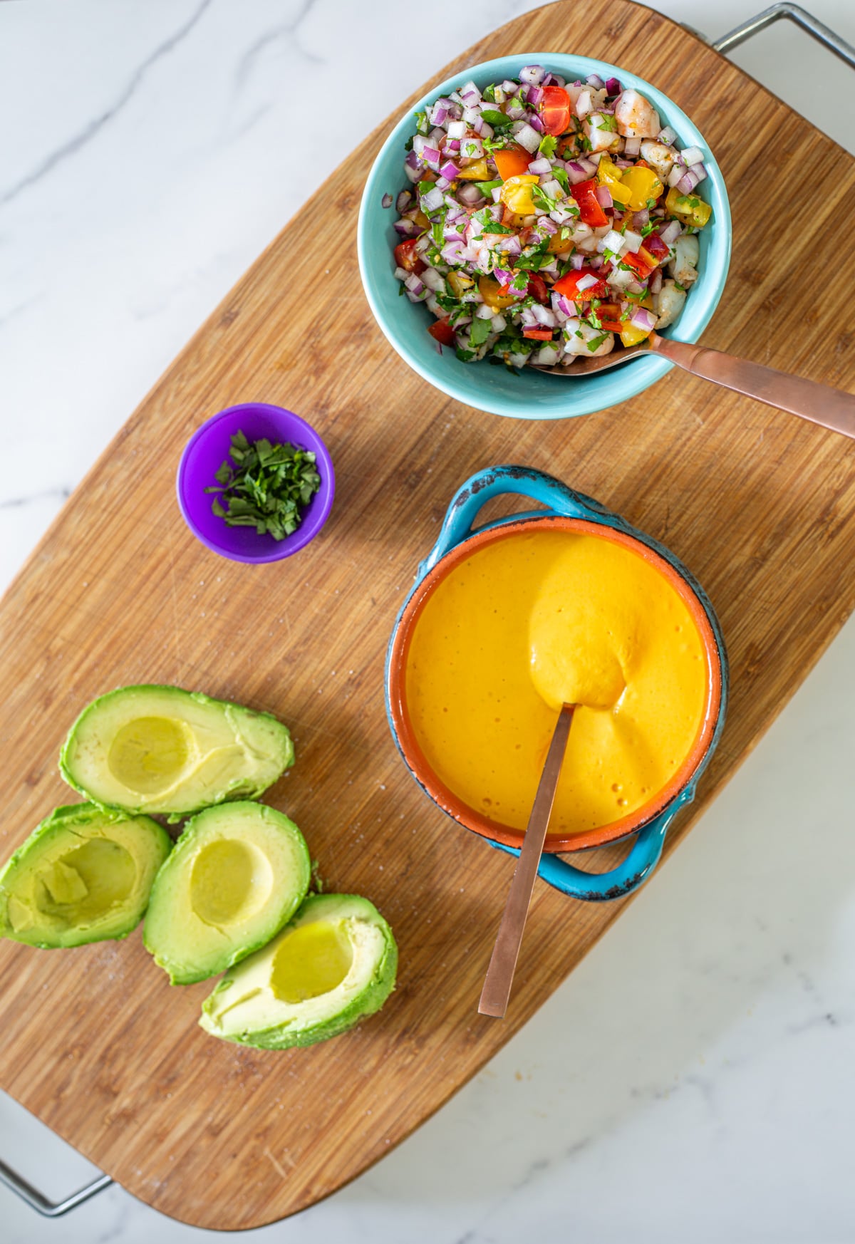 Ingredients on a wood cutting board ready to assemble the palta rellena.