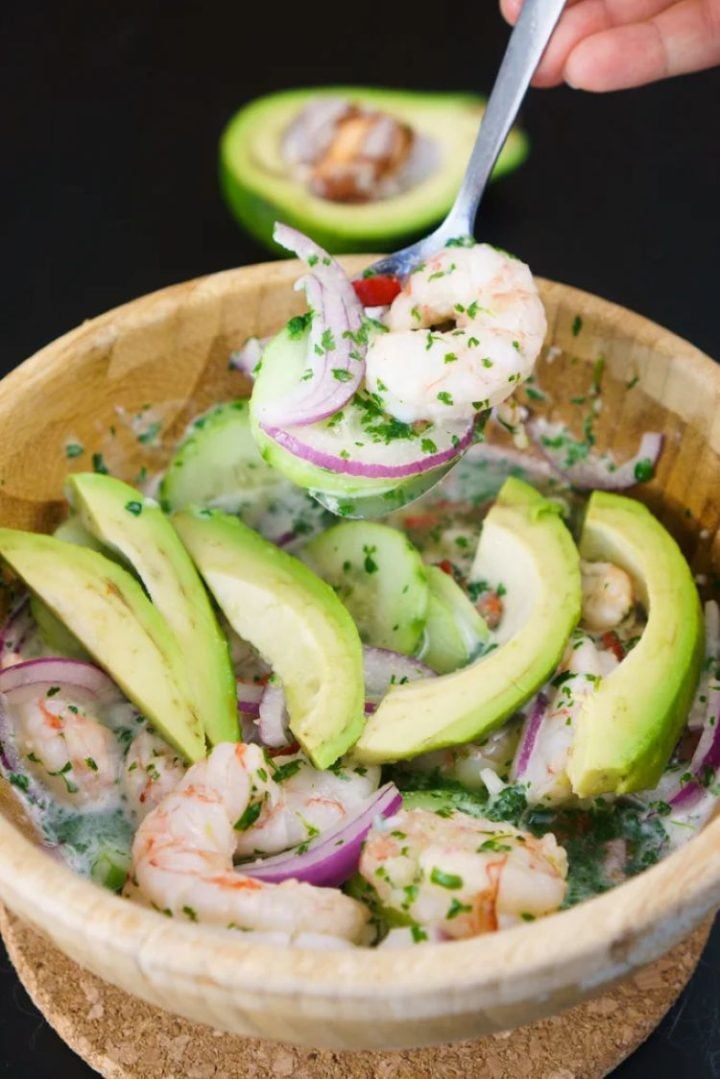 A rustic bowl of Mexican aguachile with a spoon.