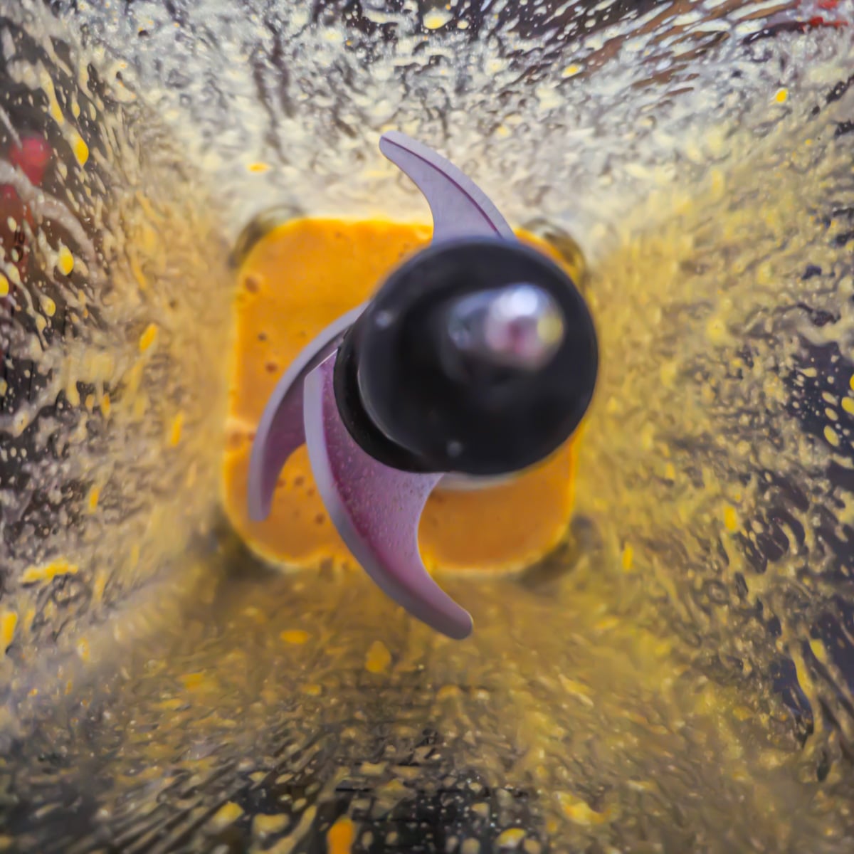 A blender with Peruvian hollandaise ingredients before add hot butter.