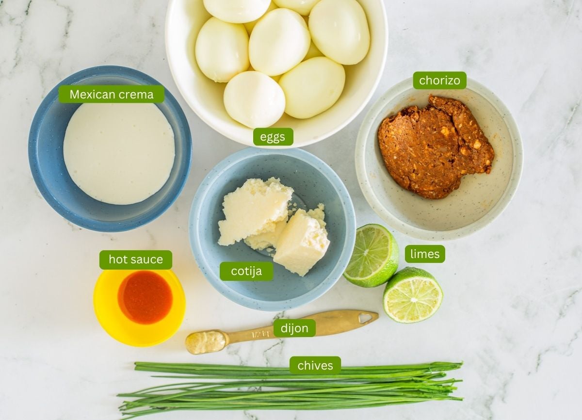 Ingredients for Mexican deviled eggs with no mayo including eggs, chorizo, and Mexican crema.