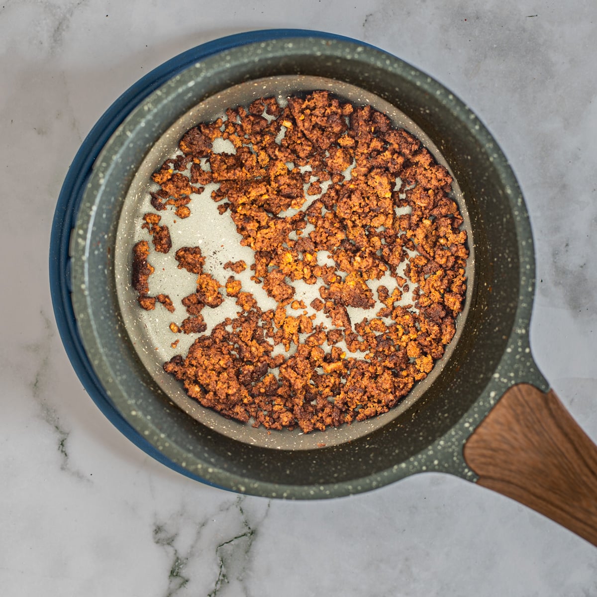 The chorizo is browned in a small saucepan.