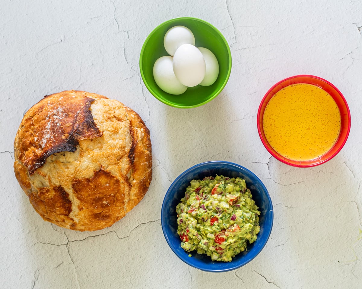 Mis en place for the Peruvian eggs benedict includes blender Peruvian hollandaise, Peruvian guacamole, eggs for poaching, and rustic bread.