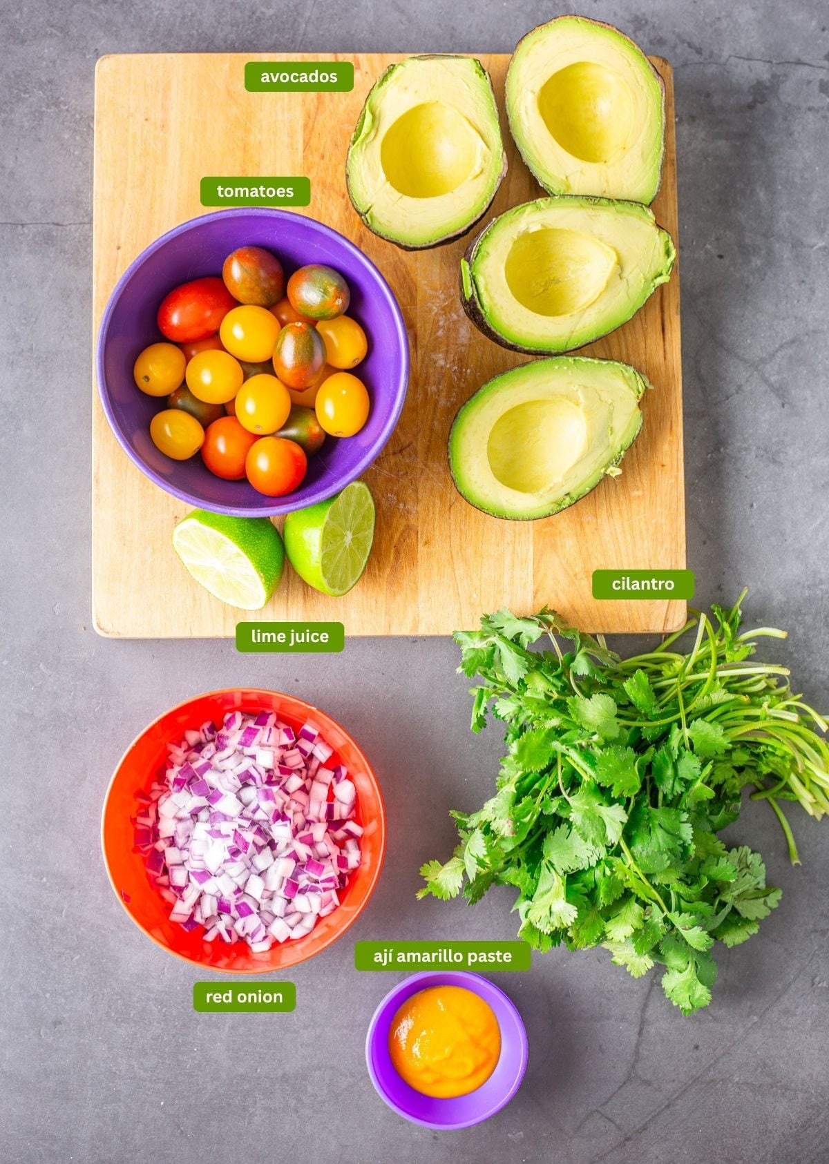 Ingredients for Peruvian guacamole: Avocados, onion, tomatoes, lime, and cilantro.