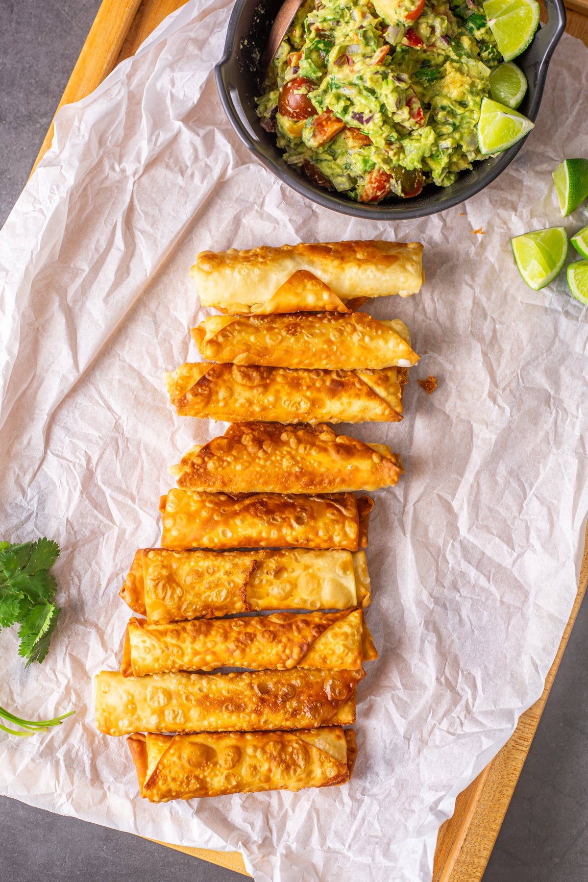 A wood tray with Peruvian Teque&ntilde;os on parchment paper.
