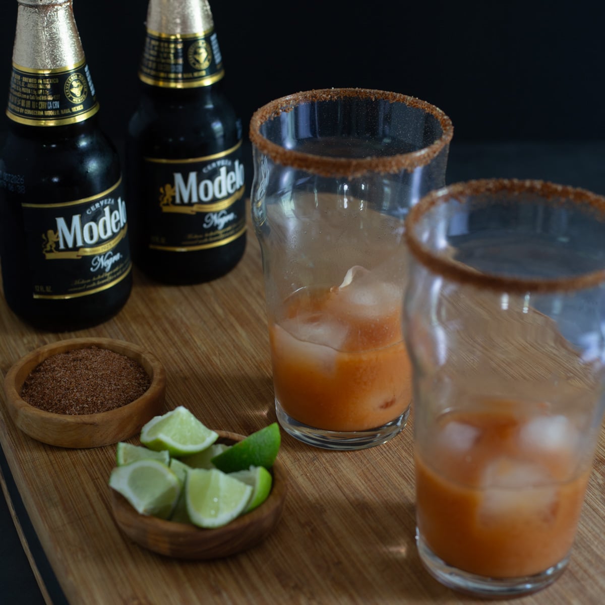Miso michelada mix is added to glasses with ice and taj&iacute;n rims. 