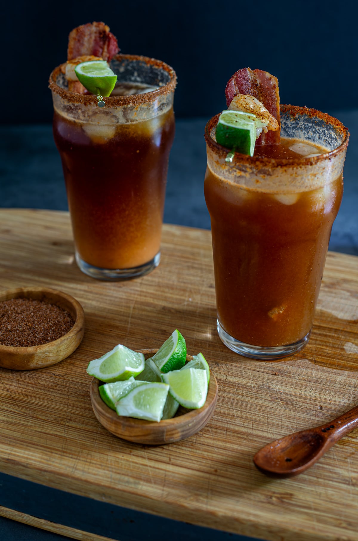2 miso micheladas in glasses garnished with shrimp and bacon.