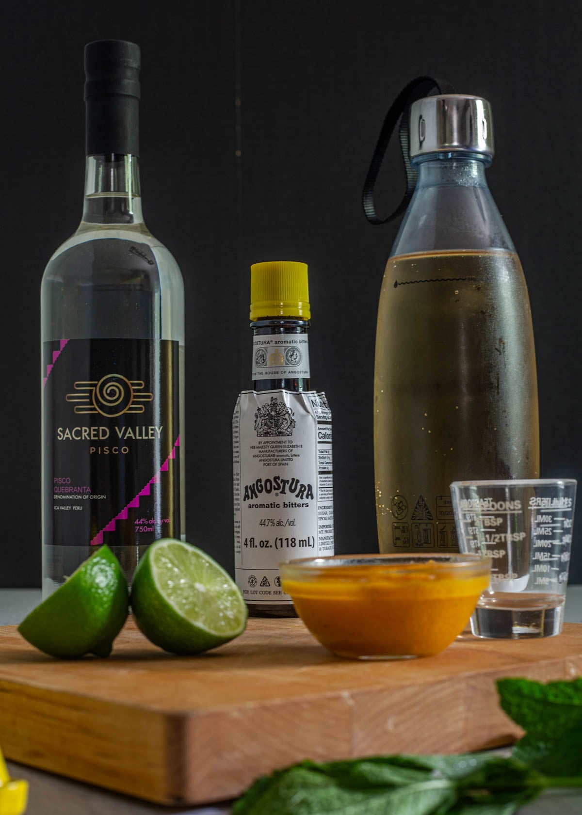 Ingredients for chilcanos - pisco, ginger ale, passionfruit/maracuya, bitters, and lime juice.