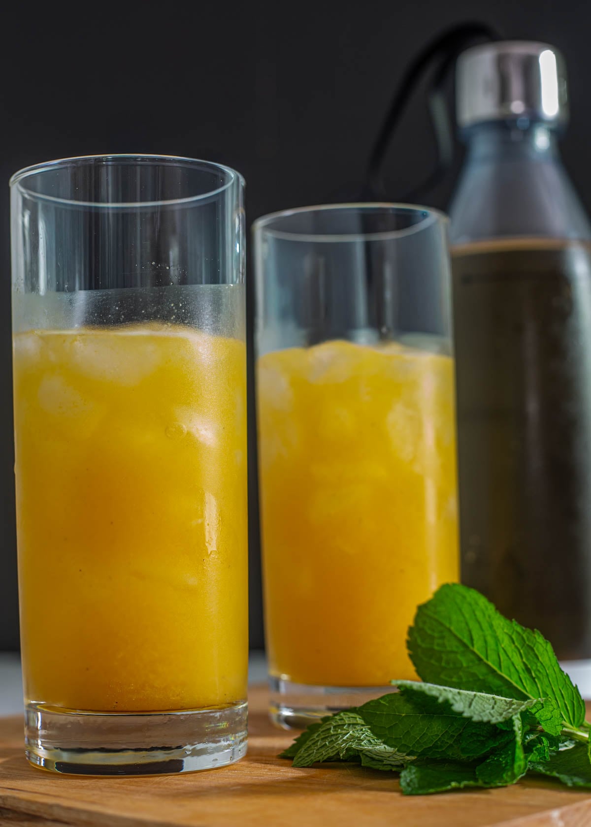 2 highball glasses  with the strained Pisco and passionfruit and a bottle of ginger ale.