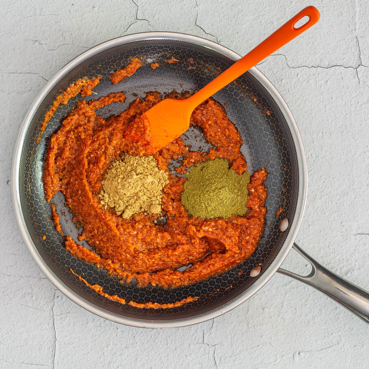 Step 1 - Onion, chipotles, and garlic are pur&eacute;ed before being sauteed in a fry pan.