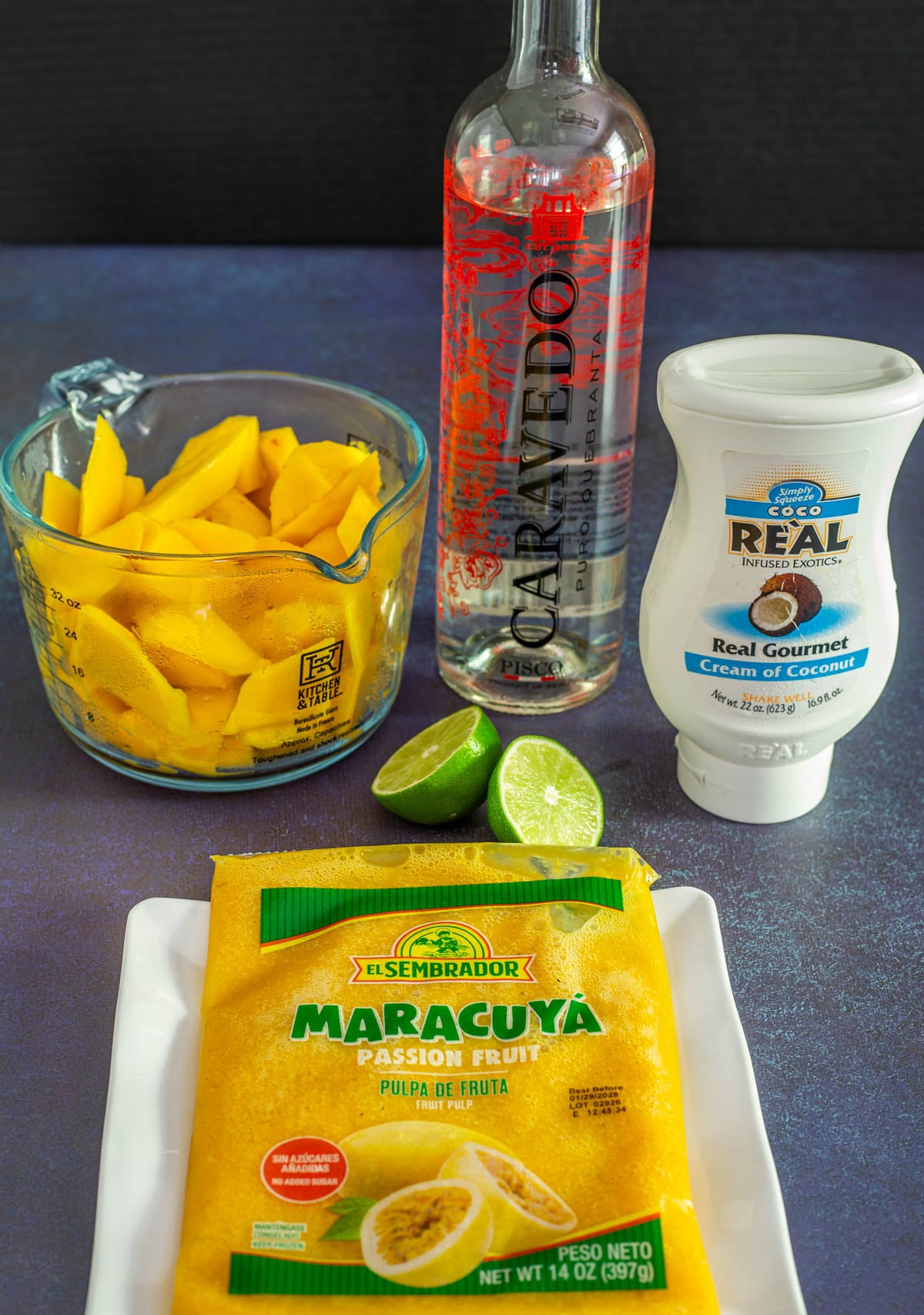 Ingredients for Passionfruit Sorbet with Mano including passionfruit pulp, chopped mango, lime, coconut cream, and Pisco.