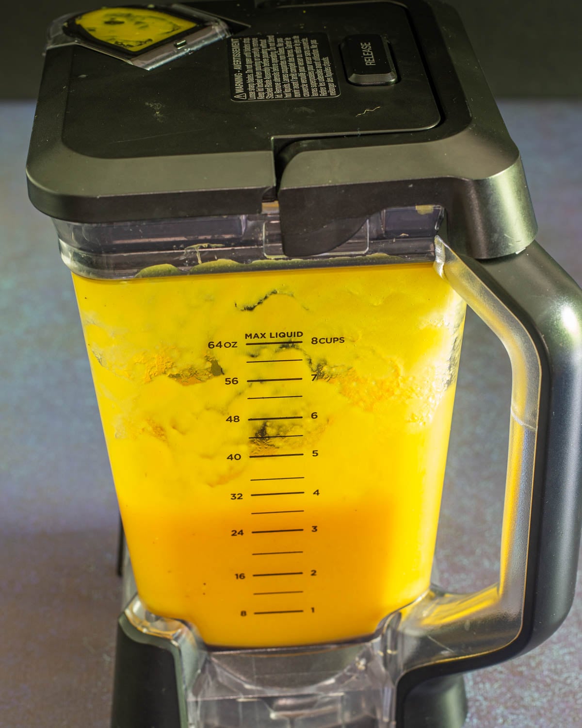Passion fruit sorbet ingredients are thoroughly blended in the Ninja blender.