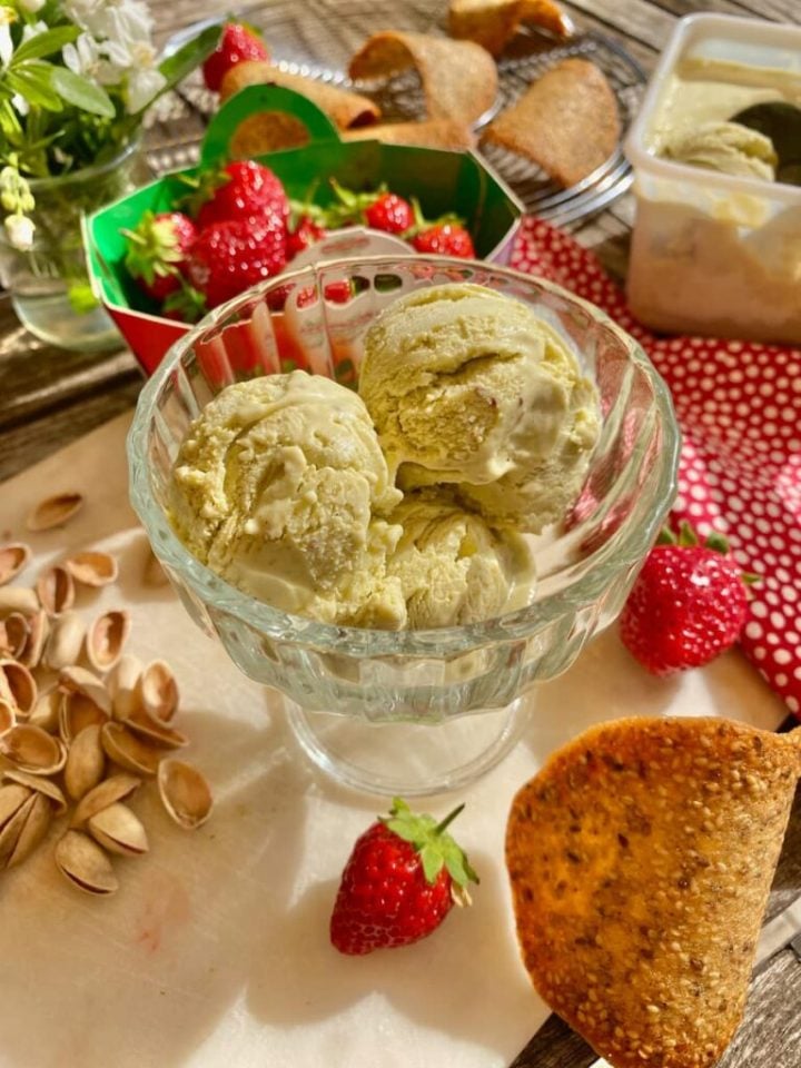 A glass ice cream dish with pistachio and wasabi custard ice cream.