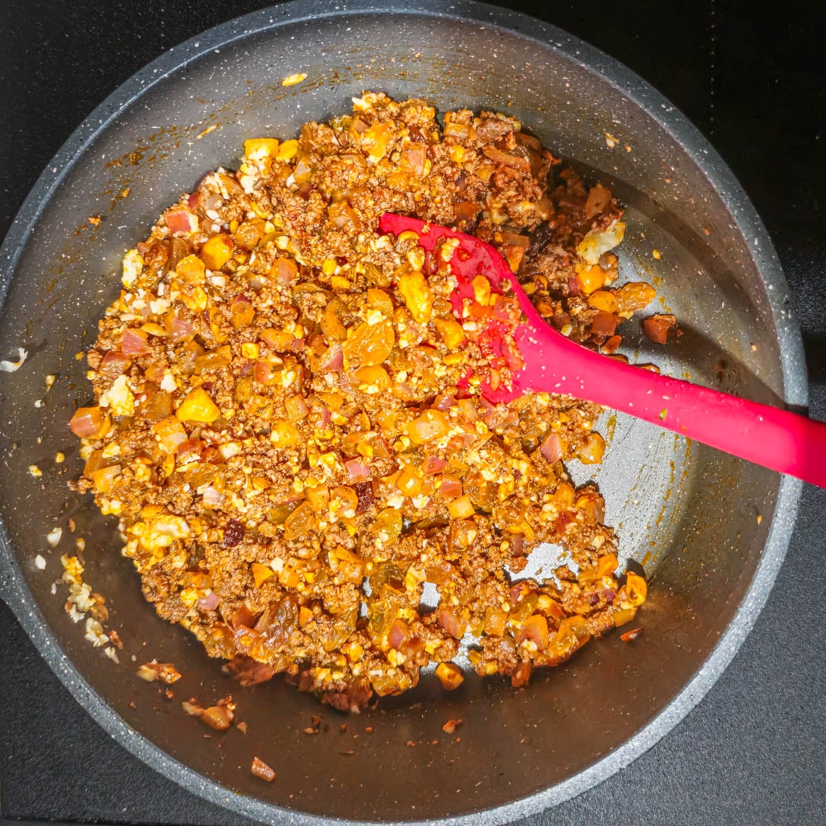 The aj&iacute; panca and amarillo paste is saut&eacute;ed with the bison.