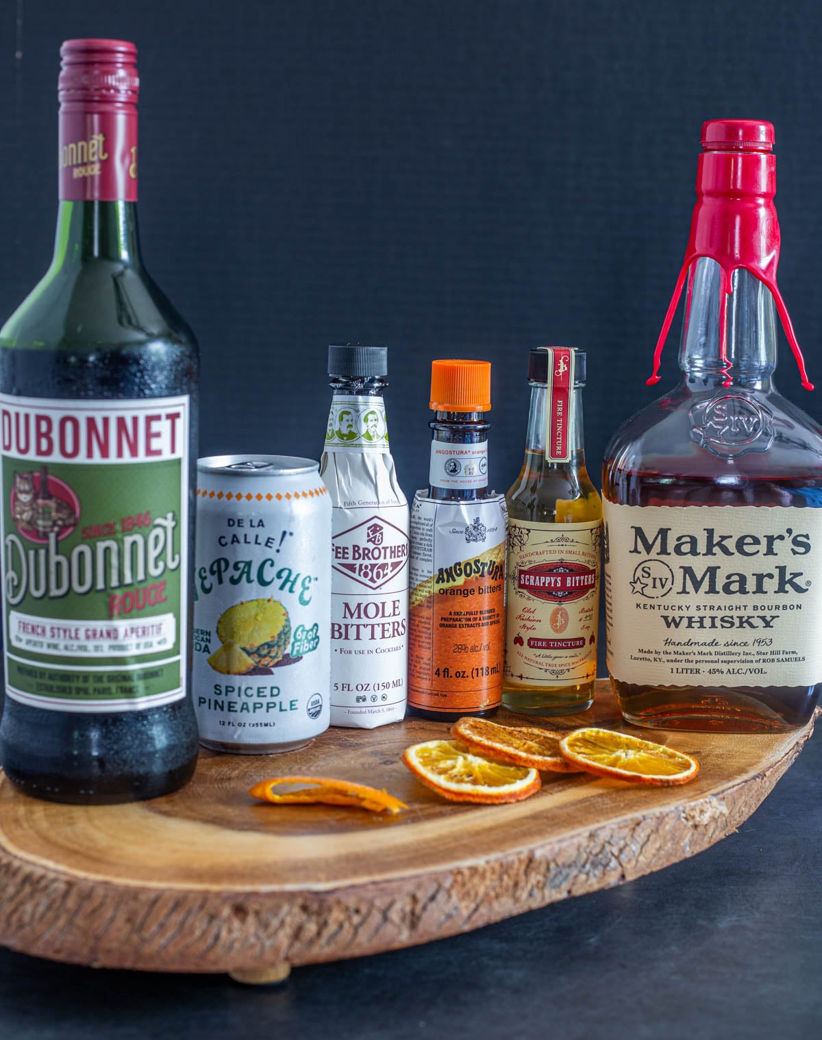 Ingredients for the tepache cocktail with bourbon - a Mexican manhattan variant - on a wood tray.