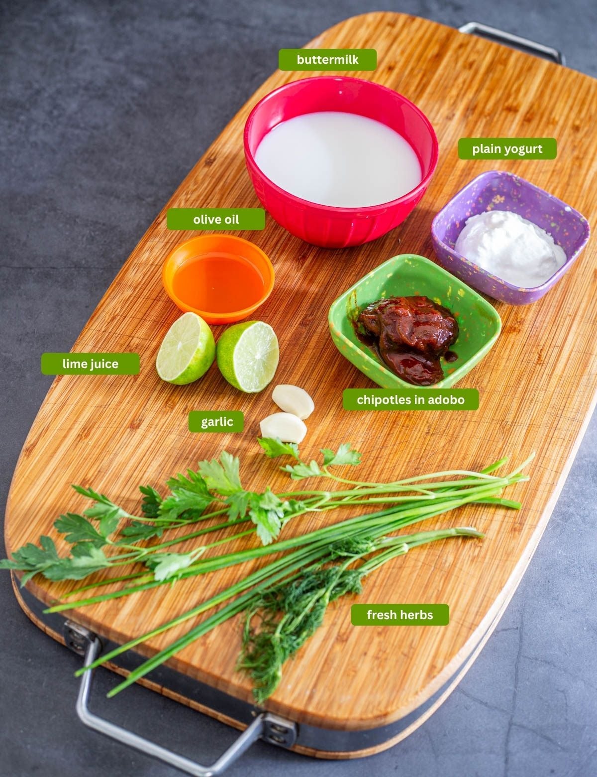 Ingredients for chipotle ranch dressing including chipotles, fresh herbs, and buttermilk.