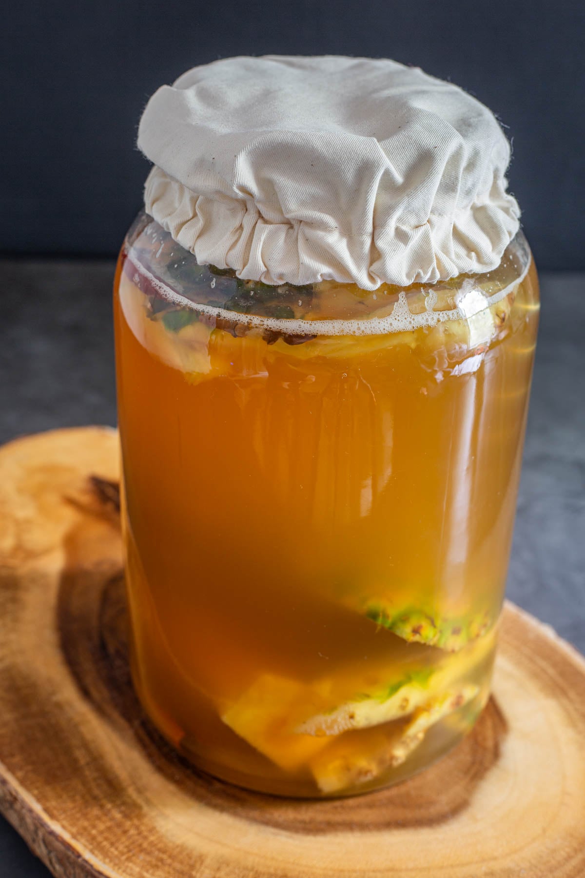 A gallon jar with the completed batch of homemade tepache before straining.