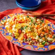 Mexican Chickpea Salad on a talavera platter with orange textile.