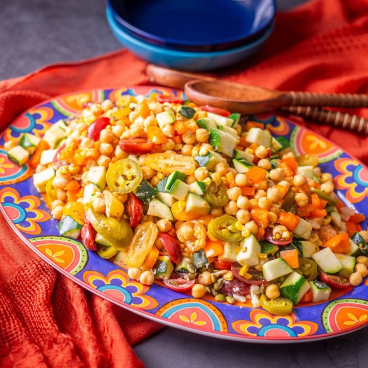 Mexican Chickpea Salad on a talavera platter with orange textile.